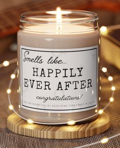 a candle that is sitting on a table with some string lights around it and the words, i'm ready now to love you most adentity right back