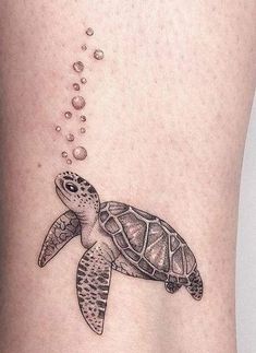 a small turtle tattoo on the ankle with bubbles coming out of it's back