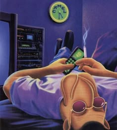 a person laying in bed holding a cell phone and looking at the clock on the wall