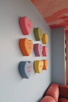 colorful heart shaped magnets are mounted on the wall