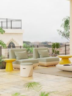 an outdoor area with couches, tables and potted plants