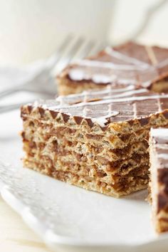 two pieces of cake sitting on top of a white plate