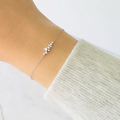 ✨ Silver Dainty Cluster Bracelet - Minimalist Layering, Bridesmaid Gift, Gift for Her ✨ Elevate your wrist with the charm of simplicity and elegance. Our Silver Dainty Cluster Bracelet is a delicate piece designed for the minimalist at heart. Whether it's a bridesmaid gift or a thoughtful gesture for her, this bracelet effortlessly combines sophistication and understated beauty. 🌟 Key Features: 🌟 Material: Crafted from high-quality silver, this bracelet ensures enduring beauty and timeless elegance. Dainty Cluster Design: The bracelet features a cluster of delicately arranged elements, creating a minimalist and stylish allure. Versatile Layering: Perfect for layering with other bracelets or wearing alone, this piece seamlessly transitions from casual to formal. Bridesmaid Gift: Capture t Dainty Adjustable Sterling Silver Wedding Bracelet, Wedding Sterling Silver Minimalist Bracelet, Minimalist Tarnish-resistant Sterling Silver Bracelet For Formal Occasions, Dainty Sterling Silver Bracelet For Bridesmaid Gift, Minimalist Sterling Silver Tarnish-resistant Bracelet For Formal, Cluster Bracelet, Cluster Design, Cluster Bracelets, Bracelet Minimalist