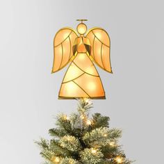 an angel lamp on top of a christmas tree