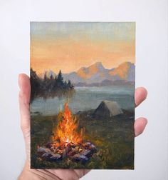 a painting of a campfire with mountains in the background