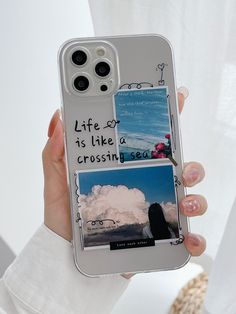 a person holding up a cell phone case with pictures on it and words written on the back