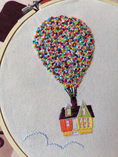 a small house with a hot air balloon in the shape of a house