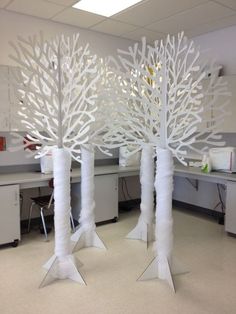 an image of some white trees in the middle of a cubicle with chairs and desks