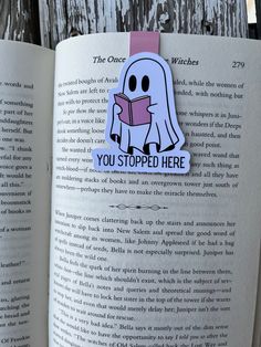 an open book with a paper sticker on it that says you stopped here