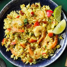 a blue plate topped with rice and shrimp