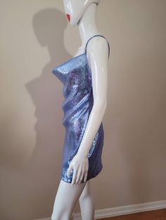 "Inspired by Dua Lipa's song \"Levitating\" It is made with a cornflower blue stretch sequin fabric. 100% lined 4 Rhinestone ornaments on the straps The skirt length from waist to hem is approximately 17\" and about 4\" above the knee (If you would like the skirt a little longer please contact me. Made to Order Sizes: Bust XS- 31-33\" Bust S- 34-36\" Bust M- 37-39\" Bust L- 40-41\" Bust Waist XS- 25-26\" waist S- 27-28\" waist M- 29-30\" waist L- 31-32\" waist Hips XS- 33-34 S- 35-36 M- 37-40 L- Blue Shimmer Mini Dress For Evening, Blue Fitted Sequin Dress For Party, Blue Shimmer Mini Dress For Party, Fitted Blue Sequin Dress For Party, Blue Shimmer Dress For Night Out, Backless Blue Sequin Dress For Summer, Blue Slip Dress With Spaghetti Straps For Party, Blue Backless Sequin Dress For Summer, Glamorous Blue Shimmer Mini Dress