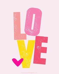 the word love is painted in pink, yellow and pink with a heart on it