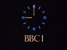 a clock with the words bbc1 lit up at night