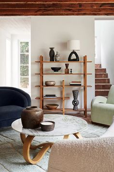 a living room filled with furniture and bookshelves