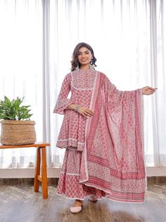 Take your fashion game to the next level with this Pheeta set of pink printed flare peplum with double flare sleeves, contrasting print yoke, crochet lace combined with two tired shararas, and printed cotton dupatta. Neck: Mandarin Collar Sleeve Length: 3/4th Flared Sleeves Kurta Length: Above Knee Fabric: Kurta & Bottom - Cotton Dupatta - Cotton Note: Wash Care Instructions - Dry Clean Only. The product will be shipped within 15-20 days of the order placed Measurements: Size Bust Waist Hip XS 3 Pink Cotton Sharara With Printed Motifs, Fitted Cotton Anarkali Sharara, Pink Semi-stitched Cotton Dress, Bohemian Pink Cotton Sets, Pink Cotton Anarkali Set With Printed Motifs, Pink Anarkali Block Print Palazzo Set, Fitted Pink Block Print Salwar Kameez, Pink Cotton Sharara With Dupatta, Pink Sharara With Printed Motifs For Navratri