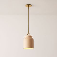 a light fixture hanging from the ceiling in a room with white walls and flooring