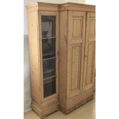 an old wooden cabinet with glass doors