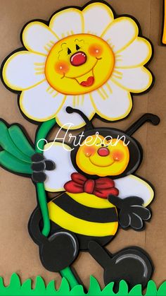 a paper cut out of a flower and a bee with a name written on it