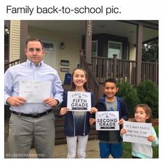 a group of children holding up signs in front of a house that says fifth grade and second grade