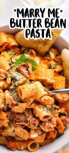 a white bowl filled with pasta and meat