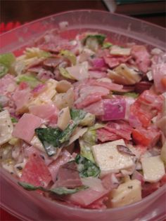 a bowl filled with lots of food on top of a table