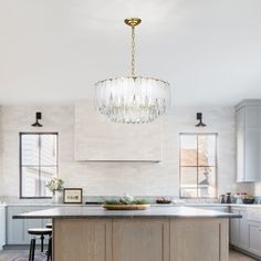 a kitchen with a chandelier hanging from the ceiling