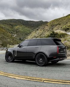 an suv parked on the side of a mountain road