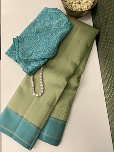 A gorgeous cardomom green pure handwoven kanchipuram silk saree with intricate threadwork in a lighter green with a contrast blue plain border flanked by a woven stripes, is a pastel lovers dream. However, what truly steals the show is the opulent woven work on the contrast pallu, adding magnificence to this already exquisite masterpiece. Sea Green Saree Blouse Combination, Kanjeevaram Sarees, Subtle Nails