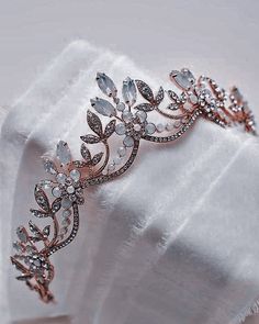 a close up of a tiara on a white cloth