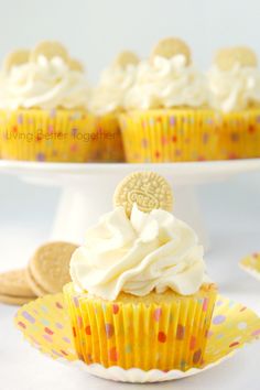 cupcakes with white frosting and cookies on top