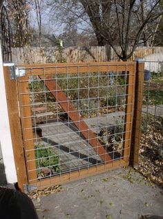 a wooden gate with metal bars on it