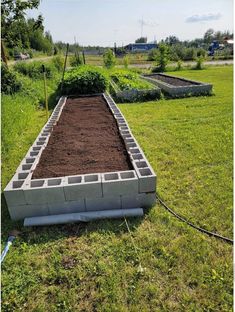 a raised garden bed in the middle of a field