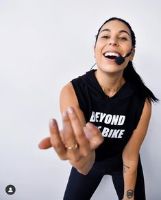 a woman wearing a black shirt with the words beyond the bike painted on her face