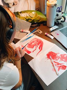 a woman sitting at a desk with headphones on