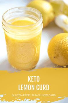 a glass jar filled with lemon curd next to two lemons