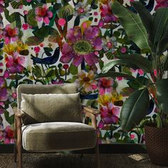 a chair sitting in front of a wall with flowers on it