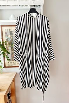 Beautifully handcrafted oversized unisex kimono with pockets and belt. Striped, printed silk fabric.  The palette is black and white. The fabric is lightweight, soft and super chic. Oversized fitting - one size. length 96 cm 148 cm waist when open - adjustable with a belt. To be washed in cold water (preferably by hand) and not to be tumble dried. Handmade with love and care in Florence. Black And White Kimono, Kimono With Belt, Printed Silk Fabric, White Kimono, Summer Kimono, Striped Fabric, Feather Light, Printed Silk, Striped Fabrics