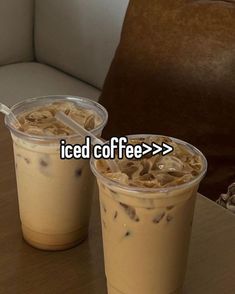 two iced coffees sitting next to each other on a table