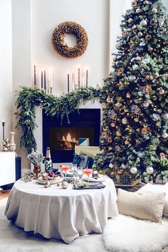 a christmas tree in the corner of a room next to a table with food on it