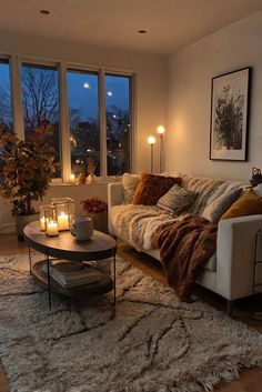 a living room filled with furniture and candles