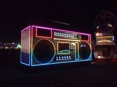 an old radio on display in the dark with lights and sound equipment around it's edges