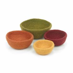 three different colored bowls sitting next to each other