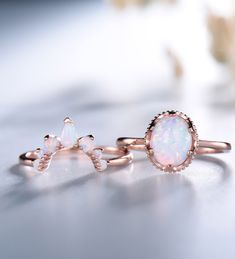 two opal rings sitting on top of each other