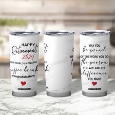 three personalized tumblers with the words happy retirement written on them, sitting on a marble countertop