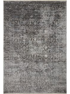 an area rug with grey and white colors on the floor, including black and gray tones