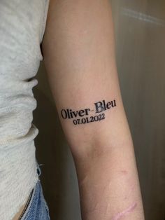 a woman with a tattoo on her arm that reads,'olver bleu 0102 022