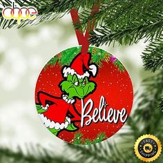 an ornament hanging from a christmas tree with the word believe in red and green