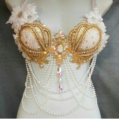 a mannequin with pearls and beads on it's chest, wearing a bra