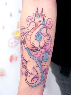 a woman's arm with a dragon tattoo on the left side of her body