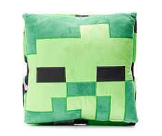 a green minecraft pillow sitting on top of a white table